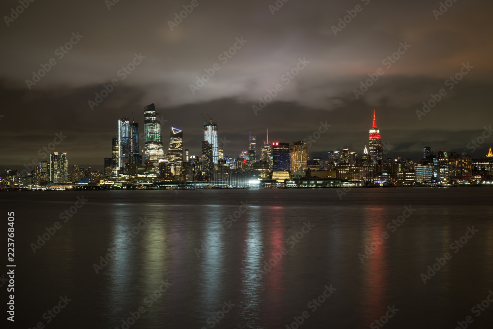 Hoboken, New Jersey - September 20 2018 - NYC Skyline with The Empire State Building Lit in Red Color to signify the NY Philharmonic Showcase
