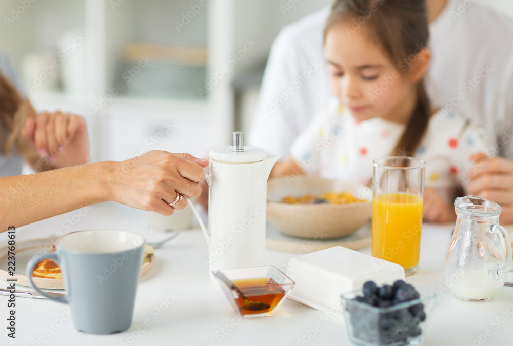 eating and people concept - close up of family having breakfast at home eating and people concept - close up of family having breakfast at home