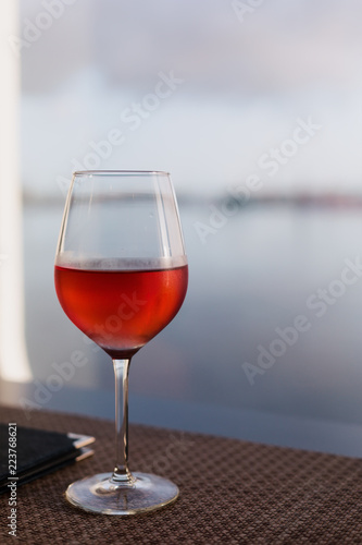Glass of rose wine closeup on table