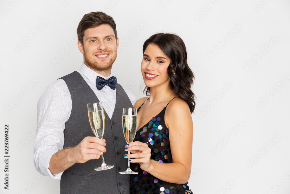 celebration and holidays concept - happy couple with glasses drinking non alcoholic champagne at party celebration and holidays concept - happy couple with glasses drinking non alcoholic champagne at party