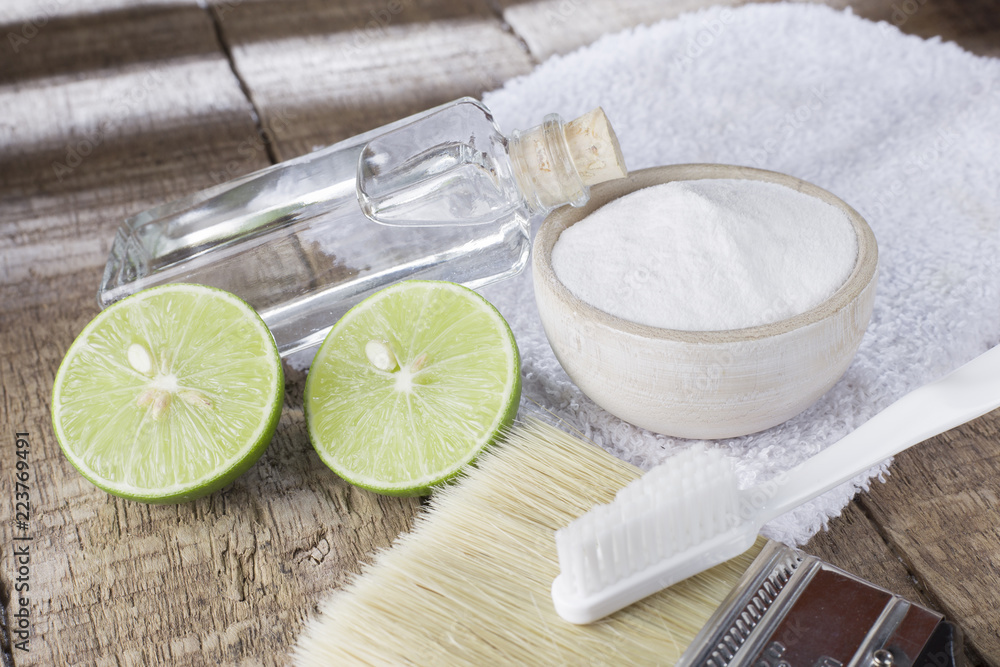 baking soda and lemon on wooden table baking soda and lemon on wooden table