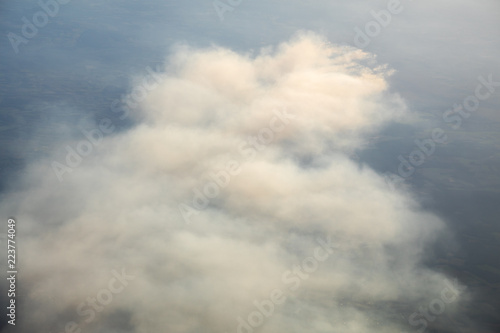 Aerial view of smoldering moor fire ignited by training activites on an army shooting range causing large smoke plumes