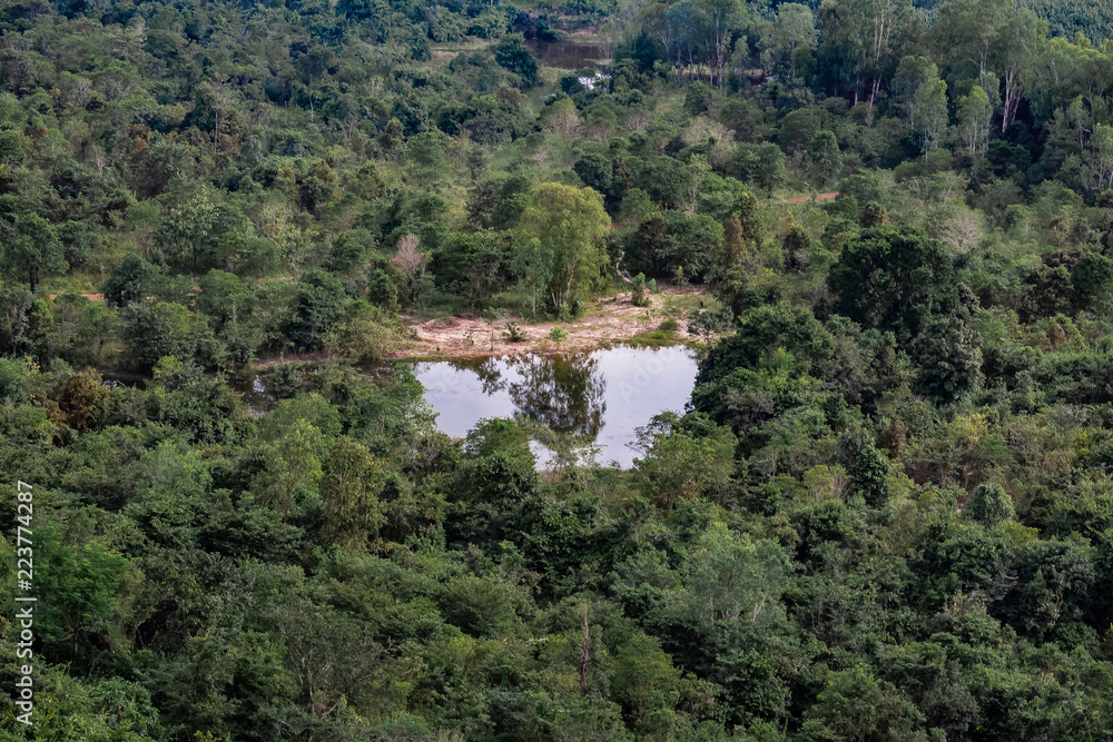 Obraz premium Aerial view of a small lake in the forest surrounding the mountain range at Phu Sing National Park, Bueng Kan, Thailand