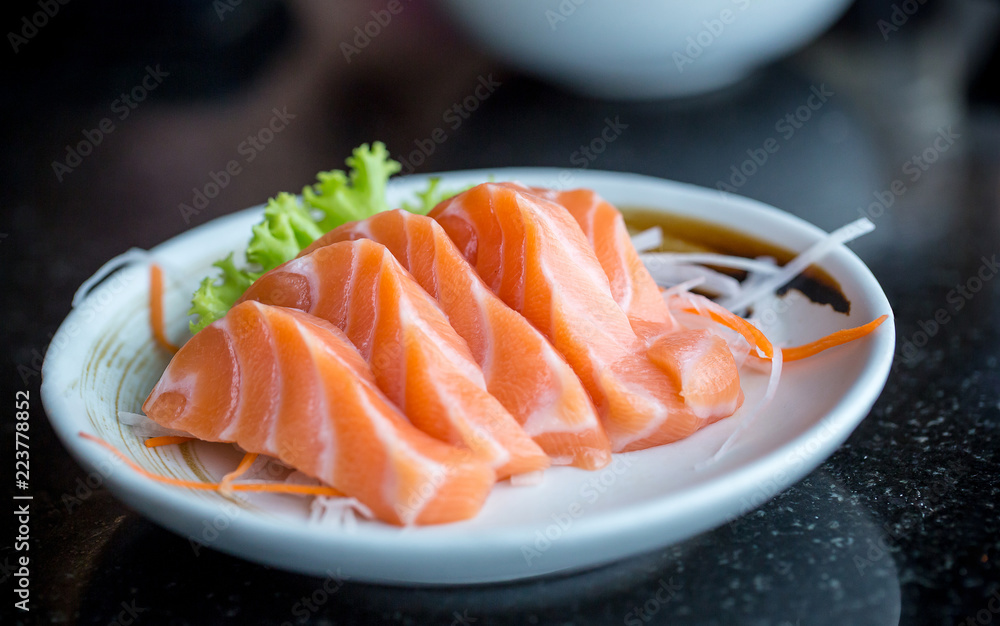 Fresh salmon slice and japanese on dish by lettuce and radish. Clean and fresh food for healthy concept. Fresh salmon slice and japanese on dish by lettuce and radish. Clean and fresh food for healthy concept.