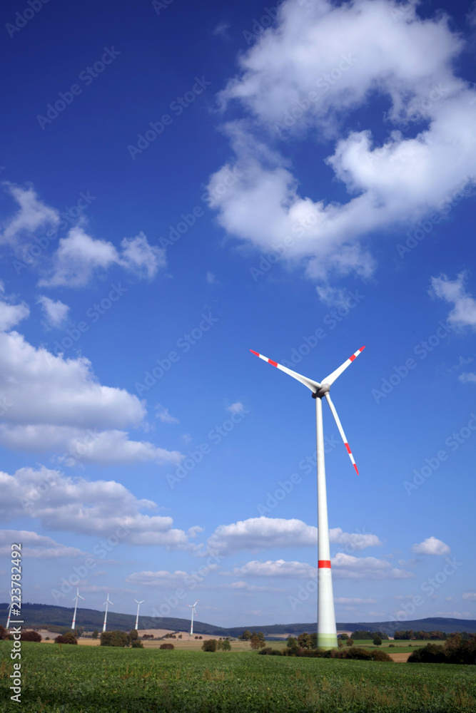 Wind turbine with energy park as background in Lower Saxony, Germany Wind turbine with energy park as background in Lower Saxony, Germany