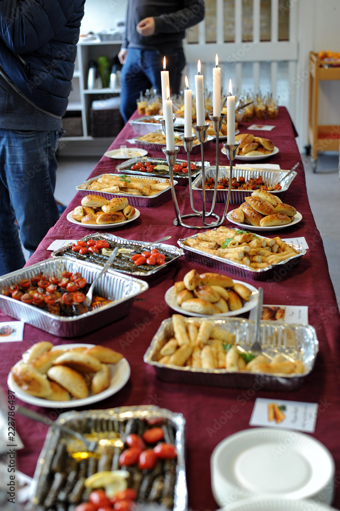 Various dishes on a wooden table served in traditional interior Middle Eastern restaurant atmosphere