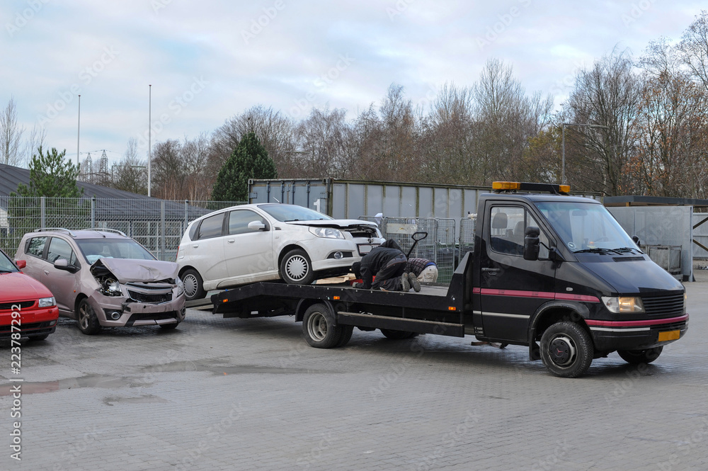 Fototapeta premium Broken car on tow truck after traffic accident