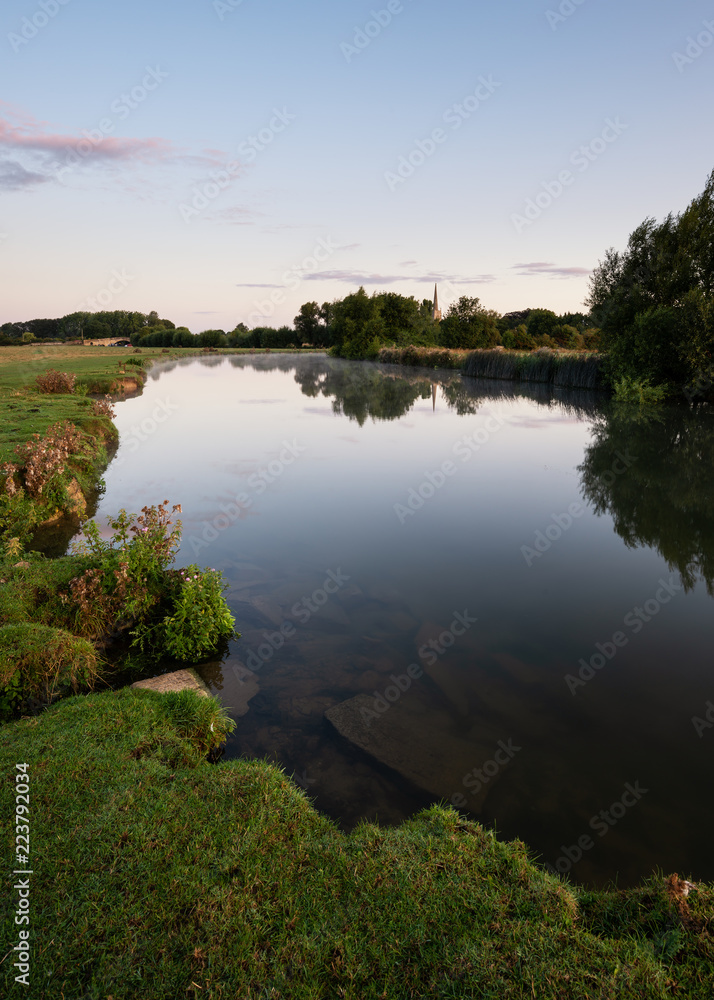 Beautiful dawn landscape image of River Thames at Lechlade-on-Thames in English Cotswolds countryside