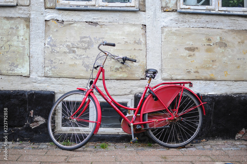 Retro vintage red bike on street in the old town. © vrej