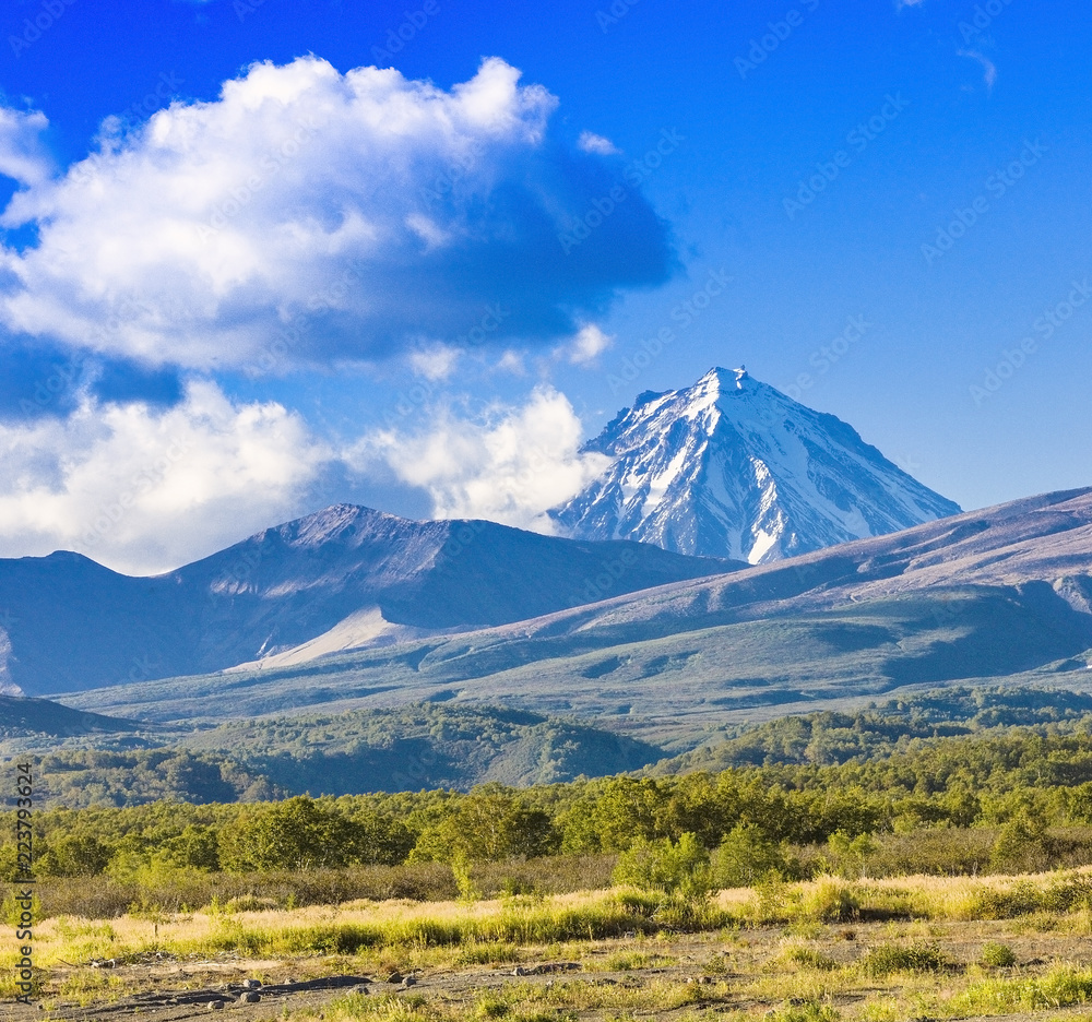 Panorama of Kamchatka volcanoes: Koryak volcano in Kamchatka in the autumn with a snow-covered top Panorama of Kamchatka volcanoes: Koryak volcano in Kamchatka in the autumn with a snow-covered top
