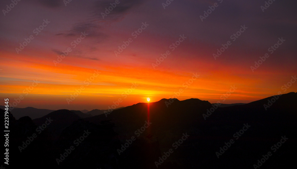 Sun In Colorful Skies Rising Over Mountains