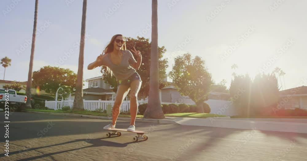 custom made wallpaper toronto digitalHappy care free girl skateboarding down street at sunset with hands up in air 
