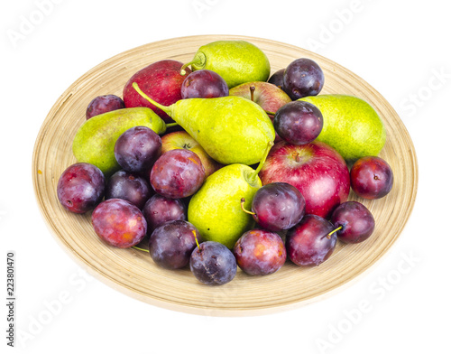 Ripe fruit on wooden plate