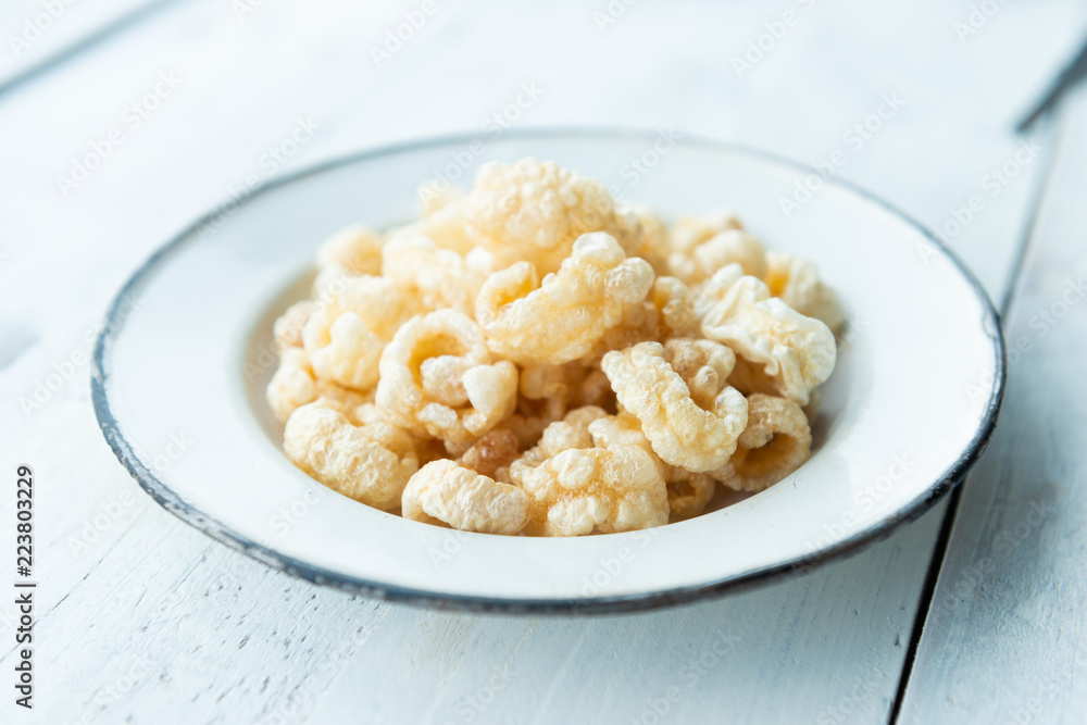 Pork rinds also known as chicharon or chicharrones, deep fried pork skin Pork rinds also known as chicharon or chicharrones, deep fried pork skin
