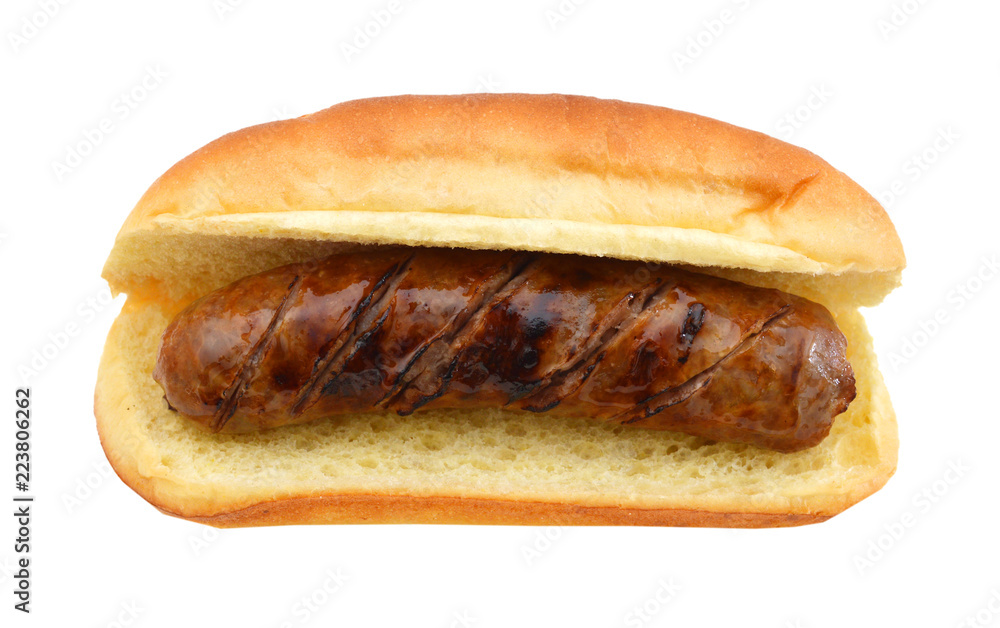 Grilled bratwurst on a bun isolated on white Grilled bratwurst on a bun isolated on white