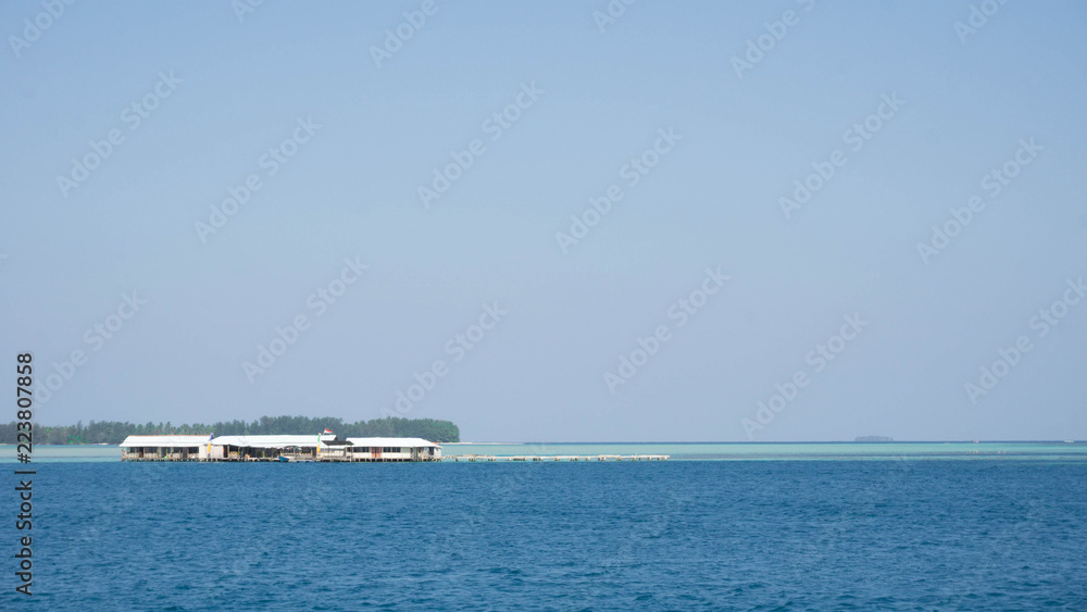 a floating house traditional with blue sea and clear sky with wood and bamboo material