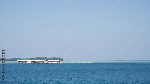 a floating house traditional with blue sea and clear sky with wood and bamboo material © maslakhatul