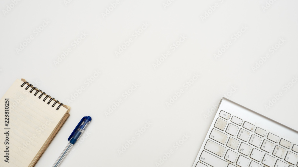 Office desk table with keyboard,and notebook Top view on white background Office desk table with keyboard,and notebook Top view on white background