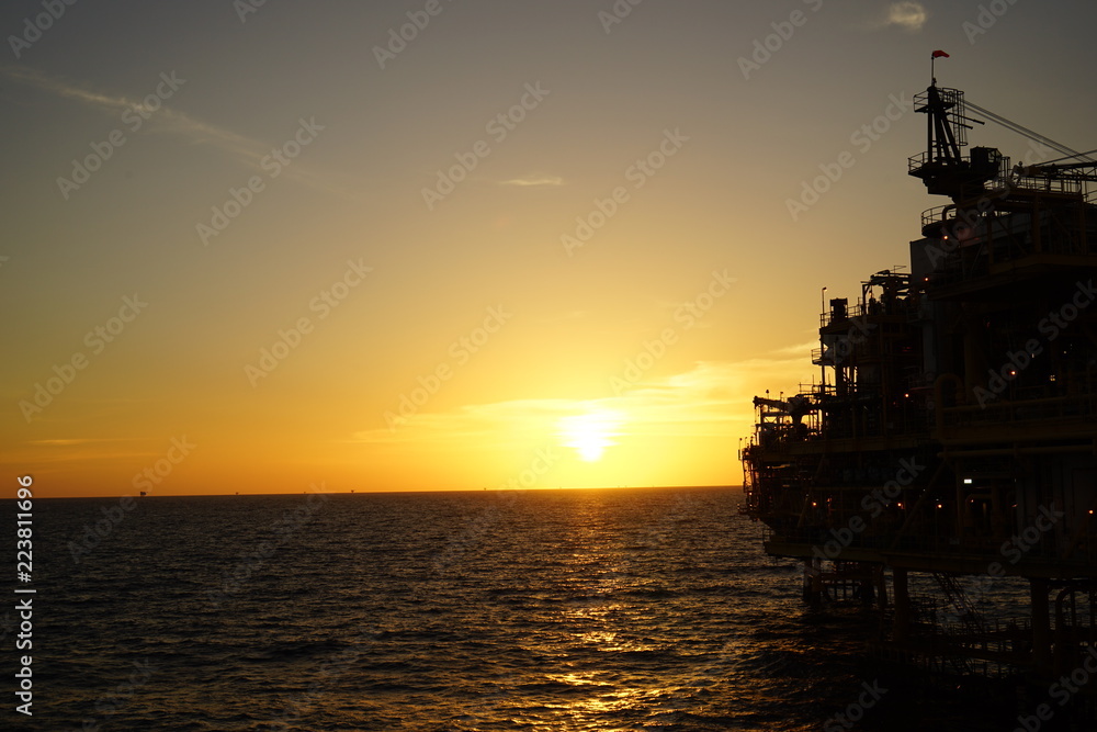 Offshore oil and gas platform sunset 