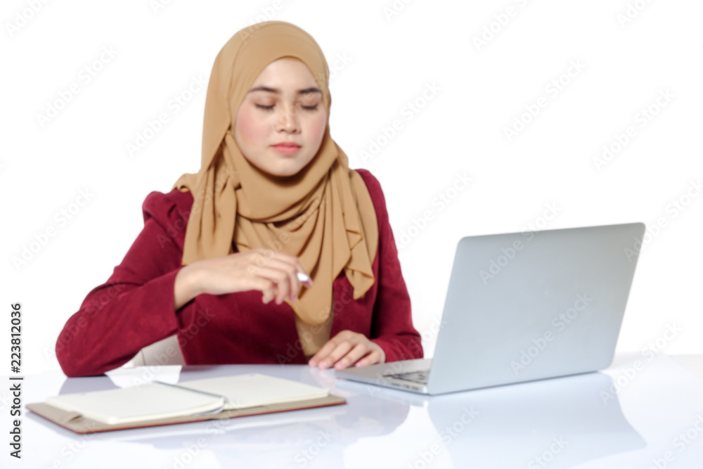 Portrait of pretty Asian hijap woman in front of laptop. Blurred image Portrait of pretty Asian hijap woman in front of laptop. Blurred image