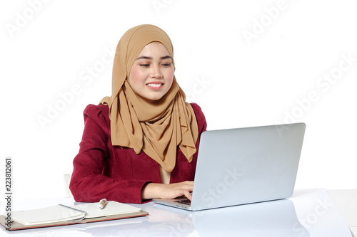 Portrait of pretty Asian hijap woman in front of laptop