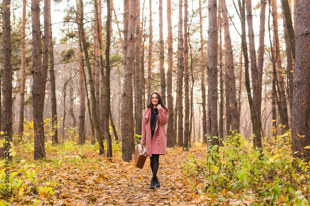 Fall, season and people concept - young woman walking in park at autumn Fall, season and people concept - young woman walking in park at autumn