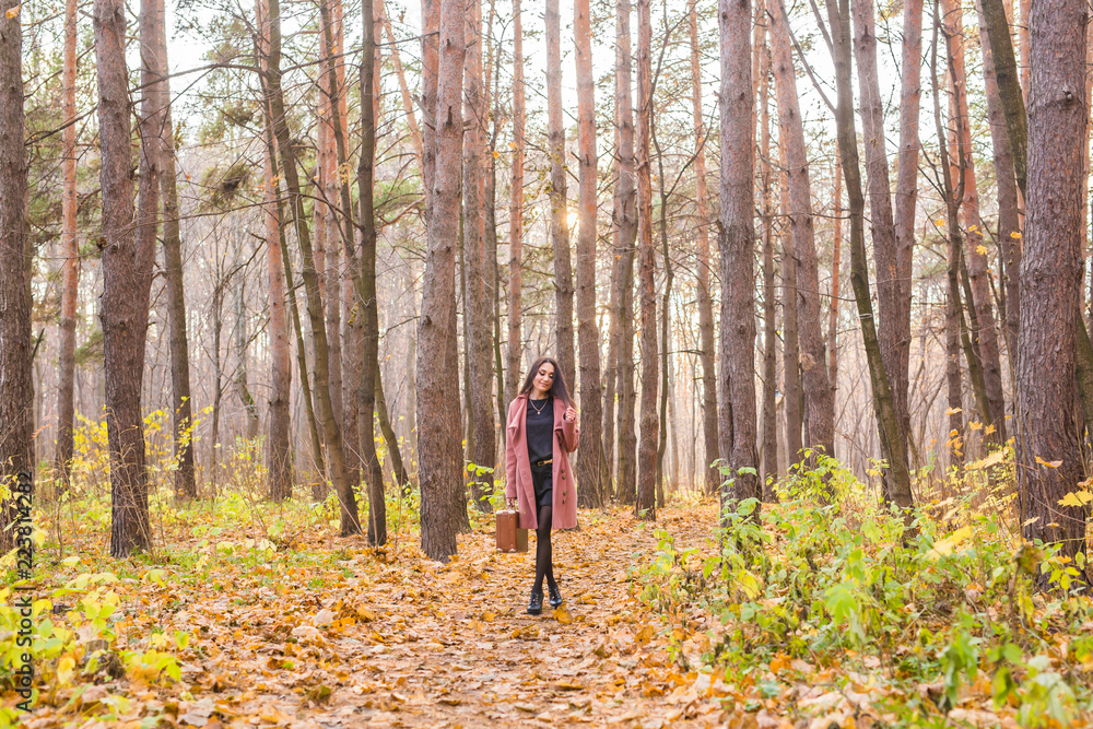 Autumn, nature and people concept - Young beautiful woman in grey coat in fall nature