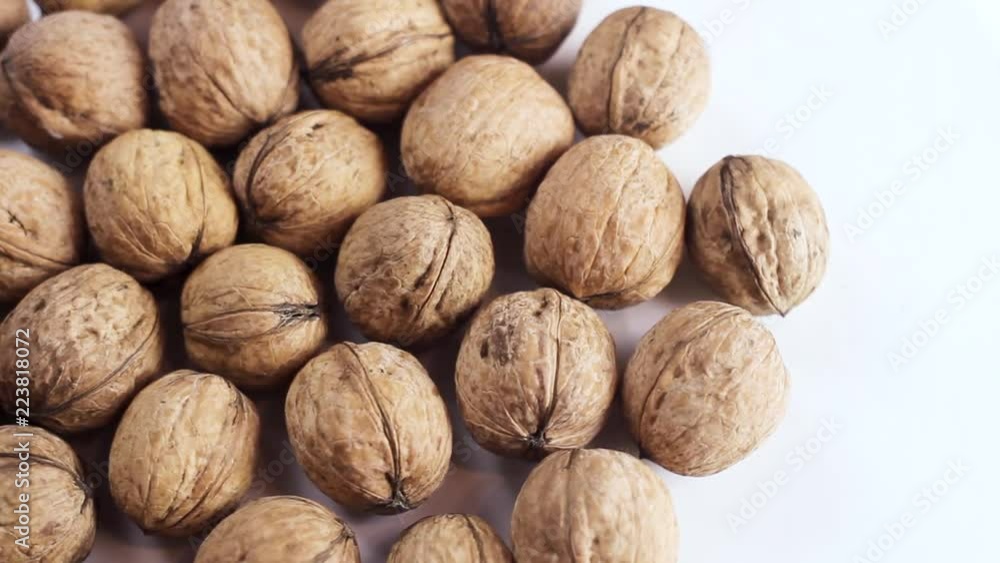Fresh walnuts rotating on white background. Close up. Fresh walnuts rotating on white background. Close up.