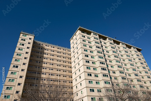 A council apartment block against a clear blue sky. Occupied predominantly by welfare recipients, immigrants and the elderly.