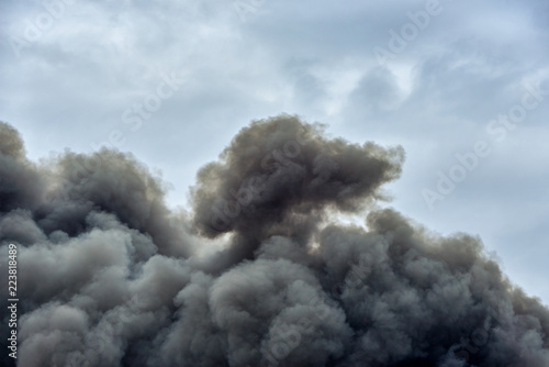 Forms and shapes in a cloud of toxic pollution smoke from a factory fire against a clean blue sky.