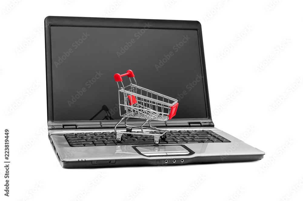 Shopping cart on opened laptop. Isolated on white. Shopping cart on opened laptop. Isolated on white.
