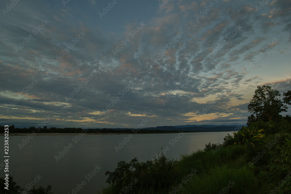 Atmosphere sunset at the Mekong river is bordered by Thailand and Laos