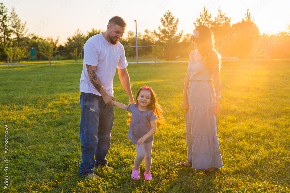 Fototapeta premium Friendly family walking in the park and have fun together