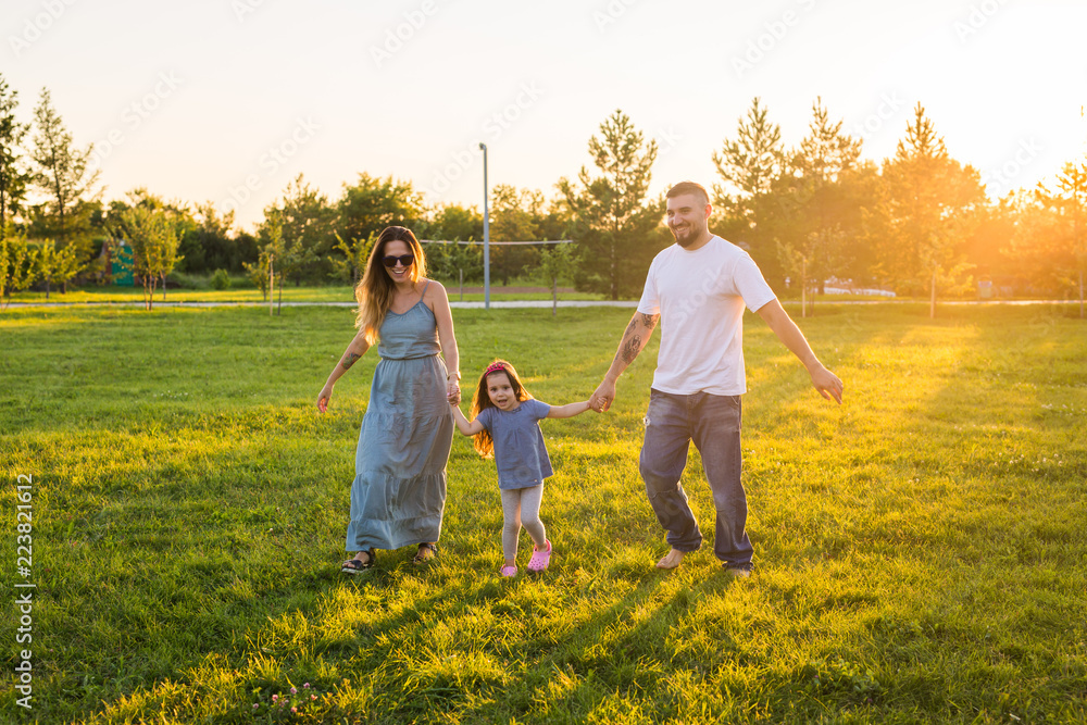 Fototapeta premium Friendly family walking in the park and have fun together