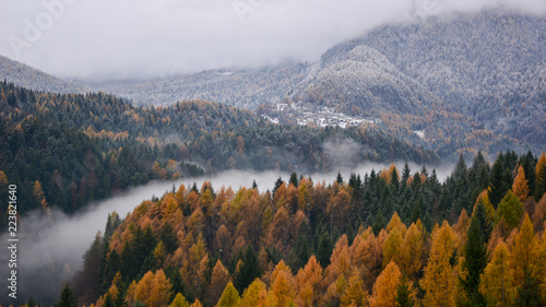 the fog in the valley of the river divides the winter from autumn