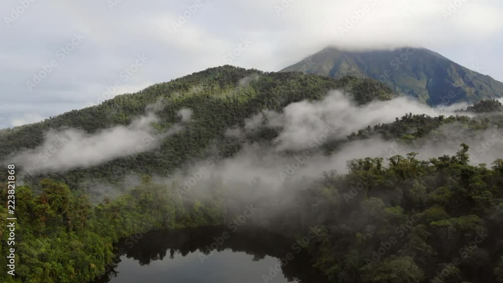 Aerial view of Sumaco Volcano with rainbow, and Laguna Wawa Sumaco, a volcanic crater lake surrounded with misty montane rainforest. In the Ecuadorian Amazon. Aerial view of Sumaco Volcano with rainbow, and Laguna Wawa Sumaco, a volcanic crater lake surrounded with misty montane rainforest. In the Ecuadorian Amazon.