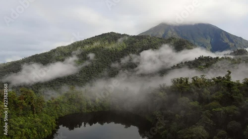 Aerial view of Sumaco Volcano with rainbow, and Laguna Wawa Sumaco, a volcanic crater lake surrounded with misty montane rainforest. In the Ecuadorian Amazon.