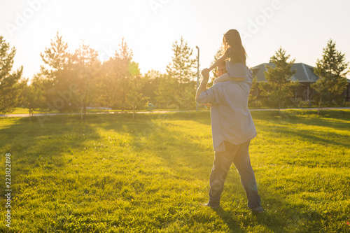 Fatherhood, family and children concept - Father and daughter having fun and playing in nature. © satura_