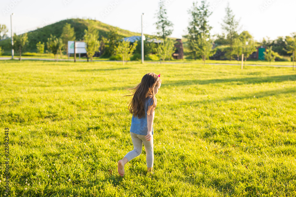 Little happy girl having fun in a summer park. Little happy girl having fun in a summer park.