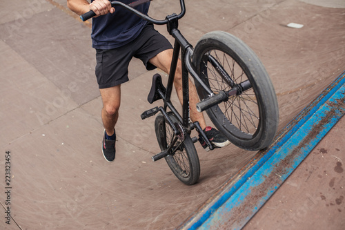 Table top in skatepark, bmx bike trick on pipe