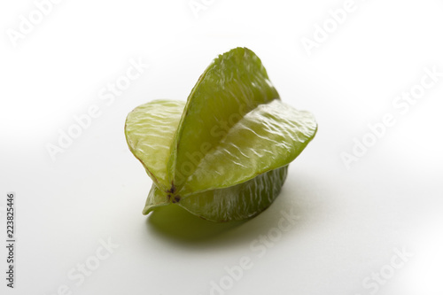Carambola or star fruit laying with reflection on a desk photo
