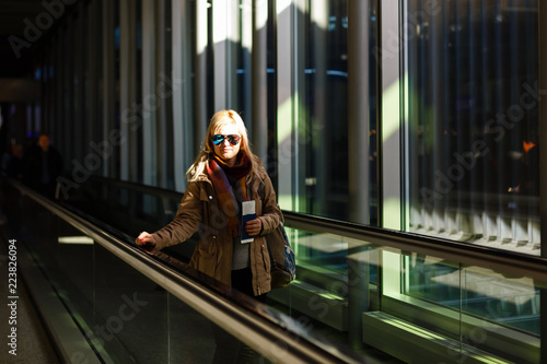 woman in modern airport, people traveling with luggage