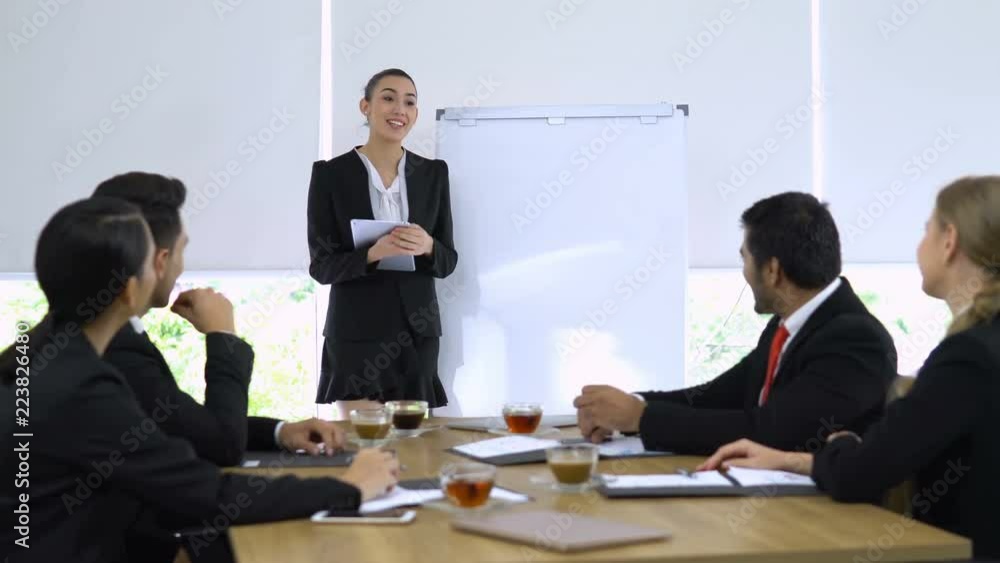 Business girl explaining about her project and everyone in meeting room agree her. Business girl explaining about her project and everyone in meeting room agree her.