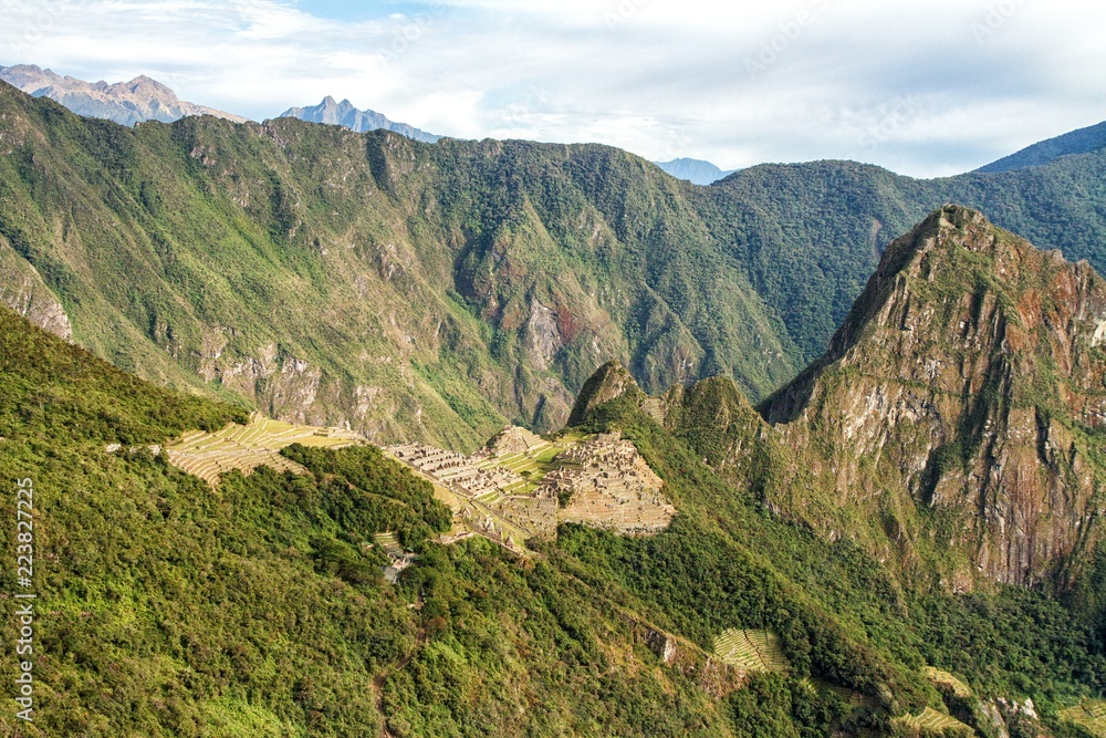 Naklejka premium View of the Lost Incan City of Machu Picchu near Cusco, Peru. Machu Picchu is a Peruvian Historical Sanctuary and a UNESCO World Heritage Site. Machu Picchu is located in the Cusco Region in Peru.