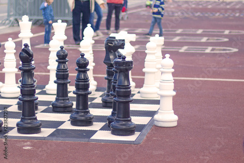 background, outdoor life-size chess stand on the sea promenade