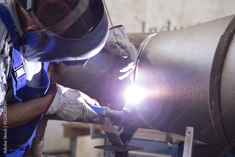 Industrie worker welding a iron pipe Industrie worker welding a iron pipe