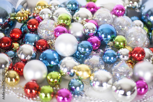 Christmas and New Year pattern, ornament of different colors glass decorative balls and tinsel, lights and sparkles, closeup