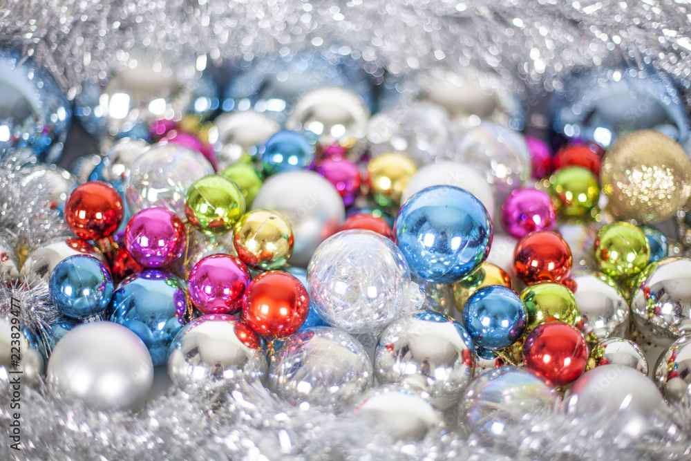 Christmas and New Year pattern, ornament of bright multi-colored glass decorative balls and tinsel, lights and sparkles, close up Christmas and New Year pattern, ornament of bright multi-colored glass decorative balls and tinsel, lights and sparkles, close up