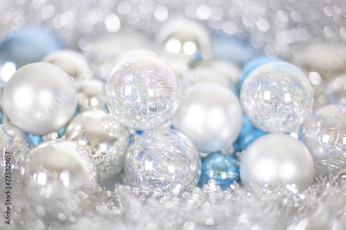 Christmas and New Year pattern, ornament of Christmas balls and tinsel, winter fairytale decor in blue and white color, lights bokeh close up