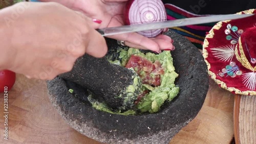 slicing onlions making guacamole in mexican molcajete